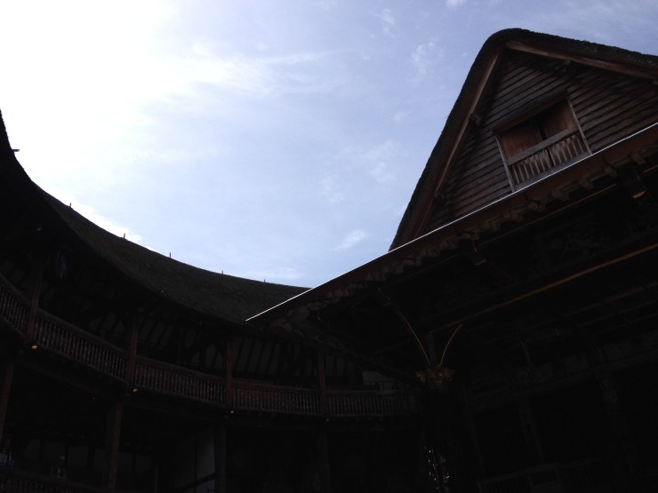 An image of a sunlit sky framed by the curve of the third (current) Globe playhouse.